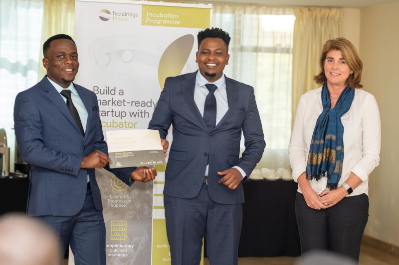 Managers in suits shaking hands in warehouse.
